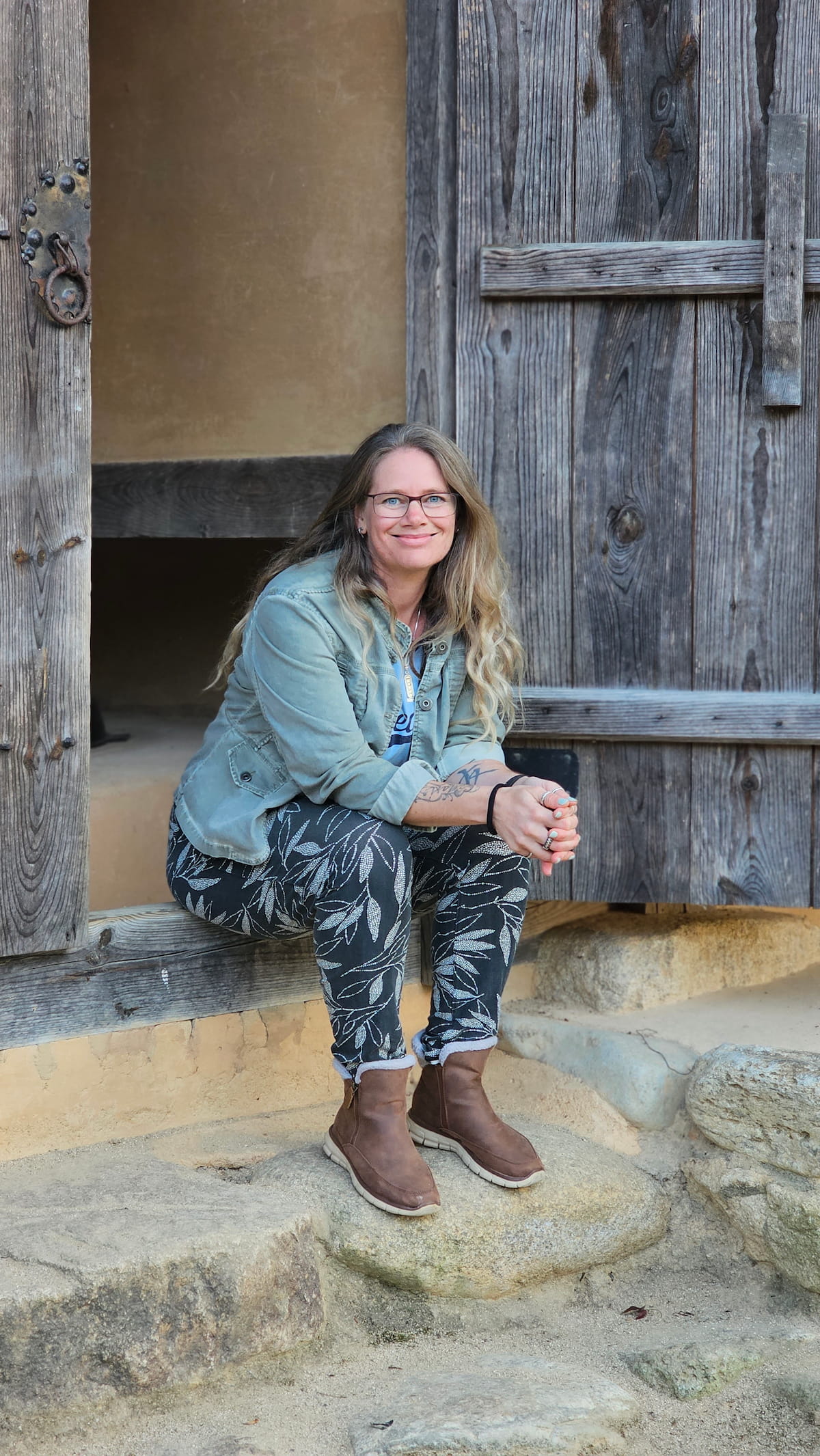 Karina sitting in a doorway in an old village in Korea